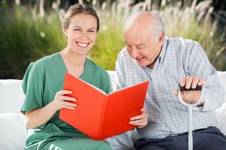 Home Care San Diego Caregiver Reading Book to Elder