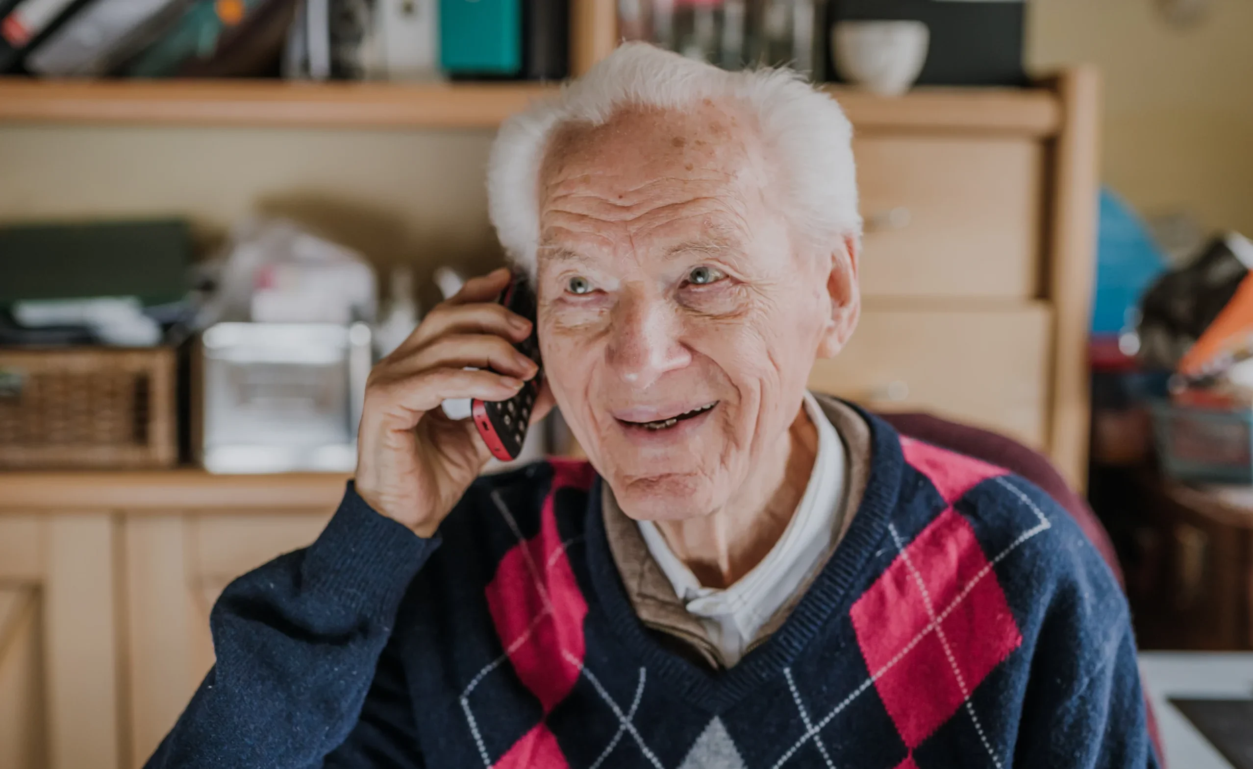 Elderly-Man-Talking-On-Phone-Sitting-At-Home-2024-10-17-05-39-59-Utc